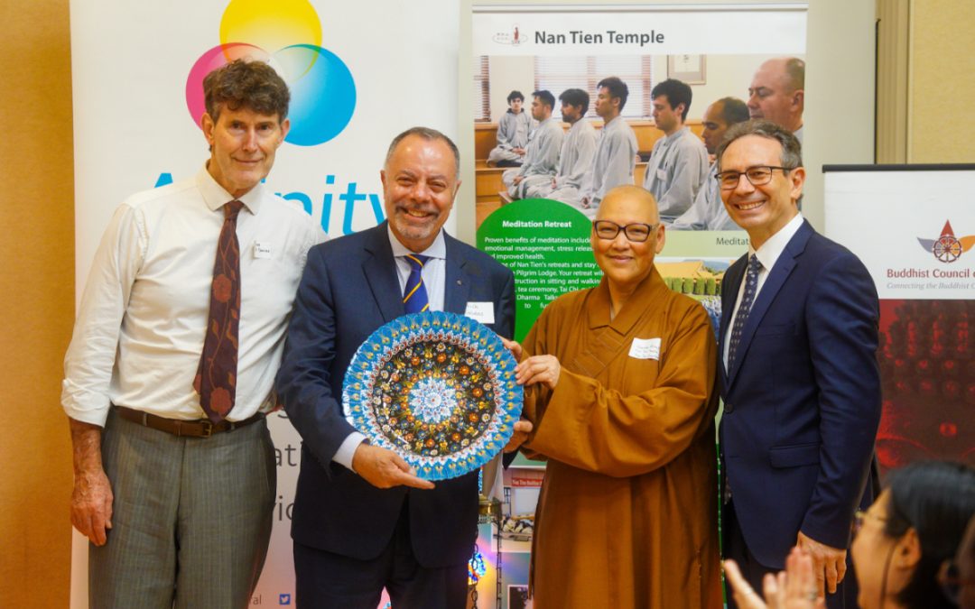 Four representatives, with one man holding a decorative plate at the Buddhist Muslim shared iftar dinner